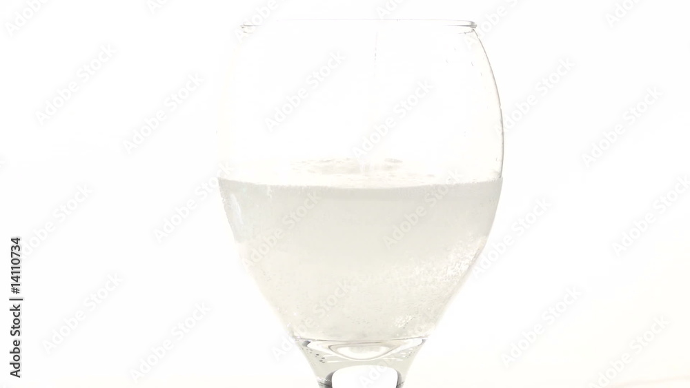 Sparkling water pour into stem glass - HD