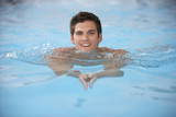 Young Man Swimming In Pool