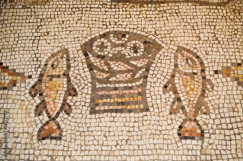 Stampa su tela Ancient mosaic at The Church of the Loaves and Fish