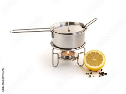 pan for mulled wine preparation and lemon