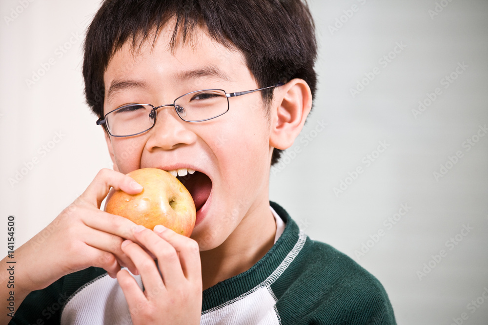 A boy eating an apple A boy eating an apple