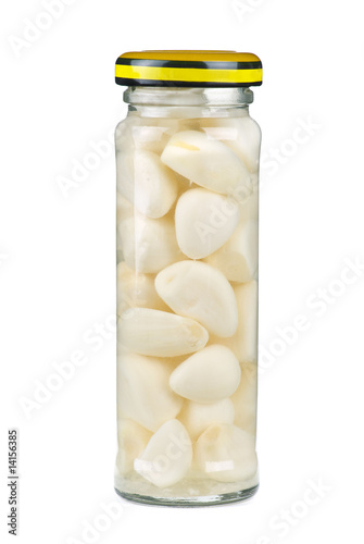 Glass jar with marinated garlic cloves