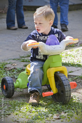 Boy on toy bike