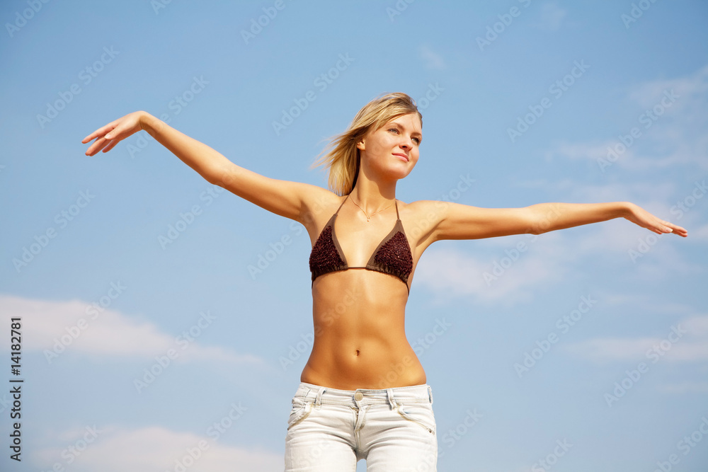 A beautiful young girl taking in the sun at the beach A beautiful young girl taking in the sun at the beach