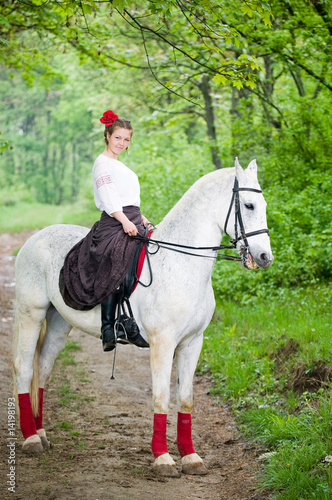 Beautiful girl riding horse © kiri