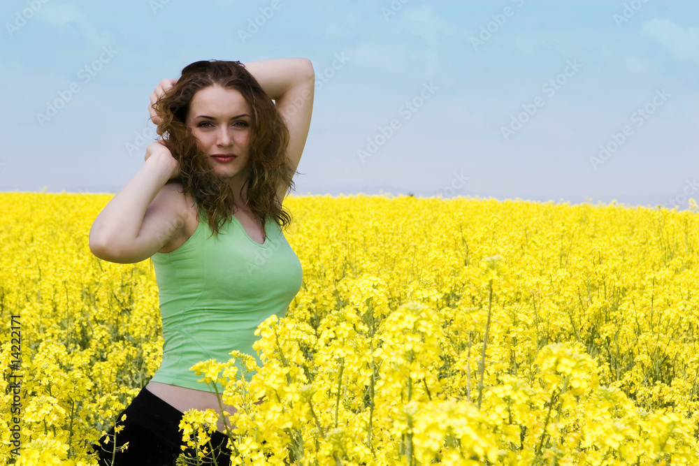 Portait of an attractive young woman in yellow rape flowers Portait of an attractive young woman in yellow rape flowers