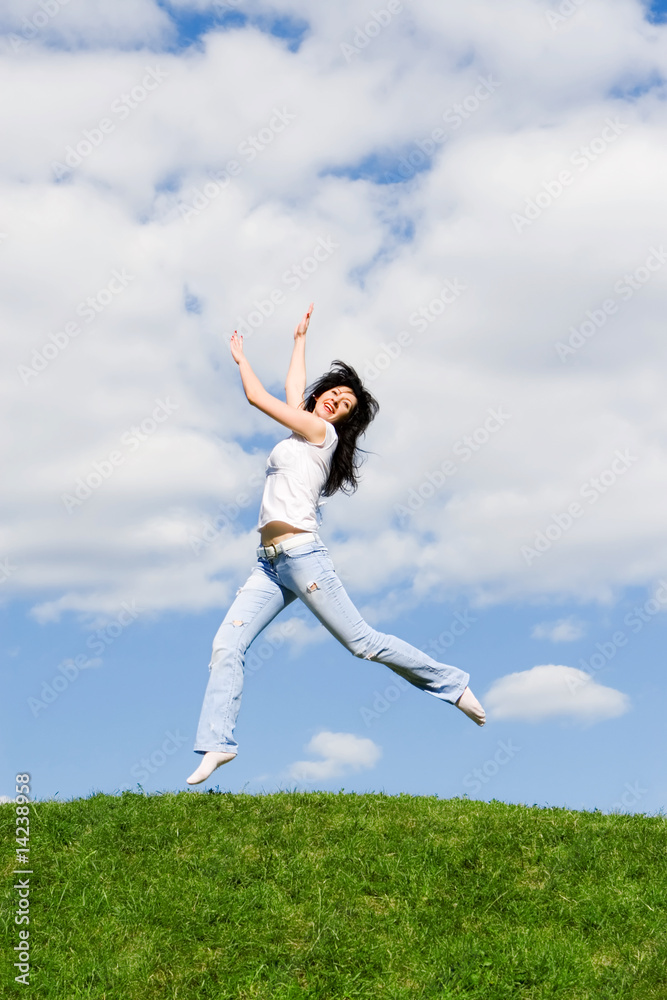 pretty young woman is jumping on green grass pretty young woman is jumping on green grass