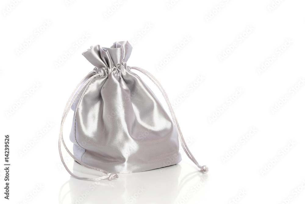 Small silk fashionable bag with cord on white background Small silk fashionable bag with cord on white background