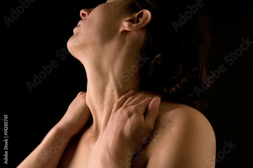 sensual portrait of woman massaging her neck