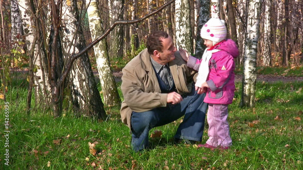 senior with little girl in autumn park senior with little girl in autumn park
