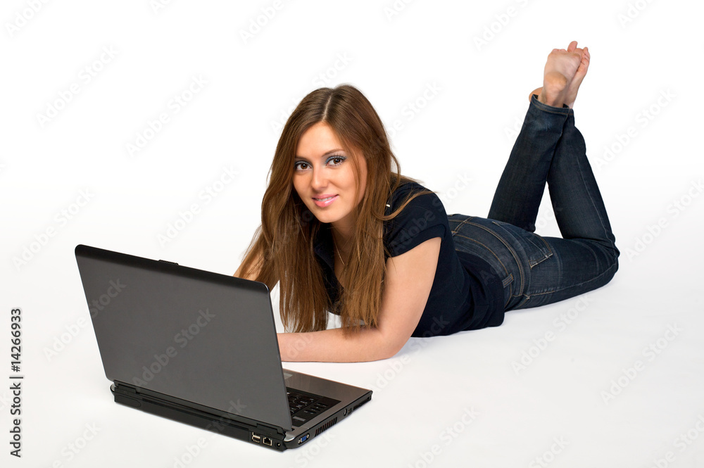Young woman lies on floor using laptop Young woman lies on floor using laptop