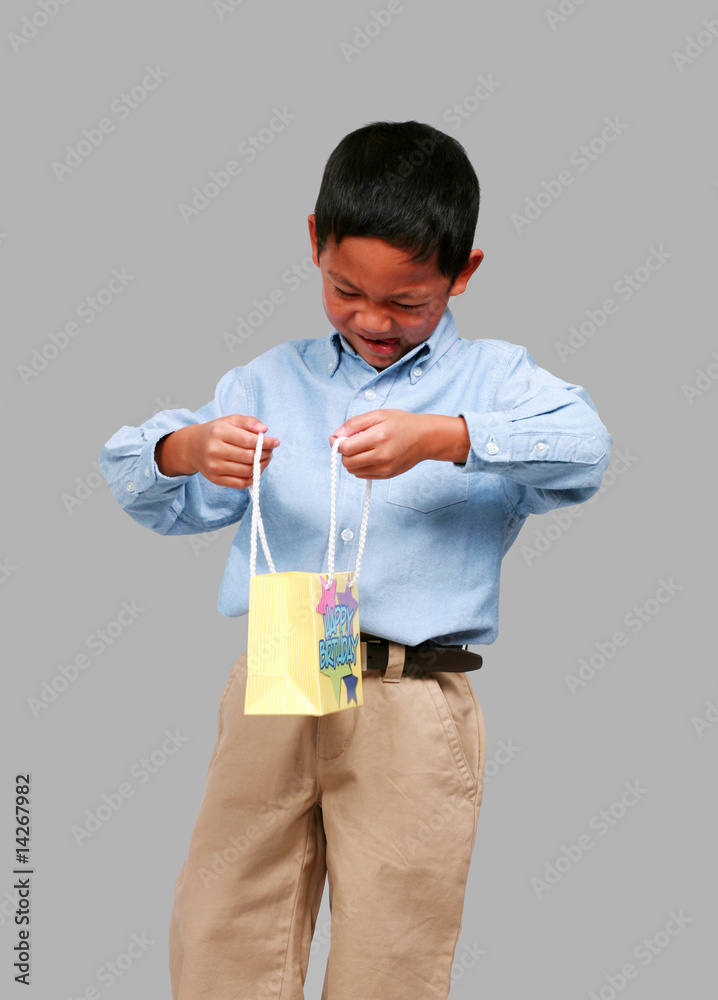 Asian boy looking in bag Asian boy looking in bag