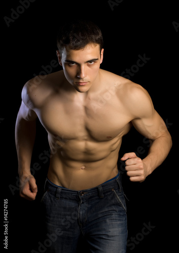Strong man running isolated on black