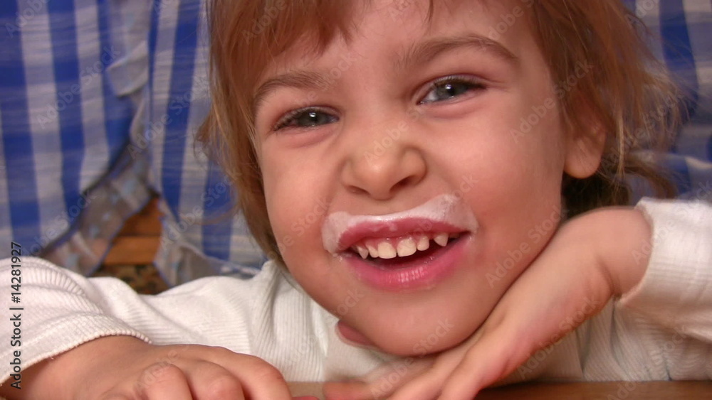 Smiling little girl with kefir moustaches. Smiling little girl with kefir moustaches.