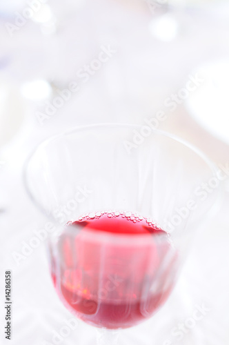 Hi-key closeup of a glass with red wine, very shallow DOF