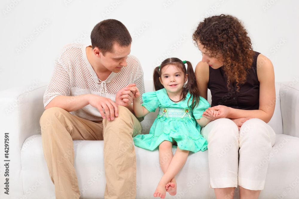Parents and daughter on white leather sofa Parents and daughter on white leather sofa
