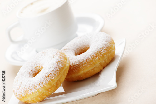 Two donuts with cup of coffee