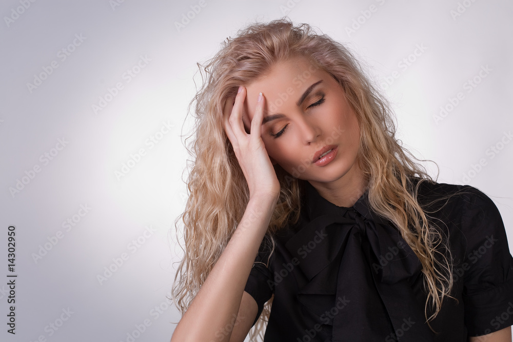 Young woman in black blouse having a headache Young woman in black blouse having a headache
