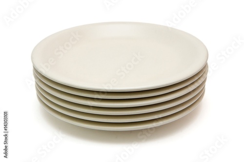 Stack of plain beige dinner plates isolated