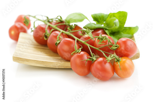 Fresh tomatoes on wooden plate
