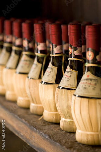Chianti wine bottles on a rack photo
