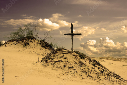 Dune landscape and old wooden cross photo