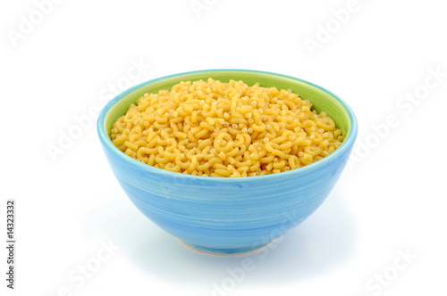Macaroni in blue bowl isolated on white background