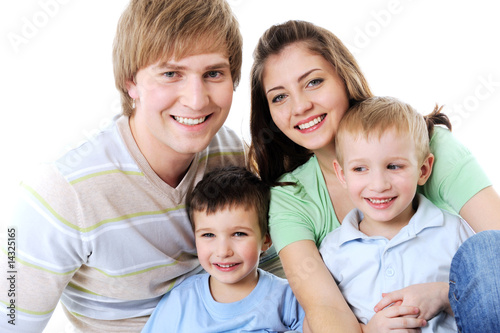 portrait of happy laughing young family with two sons