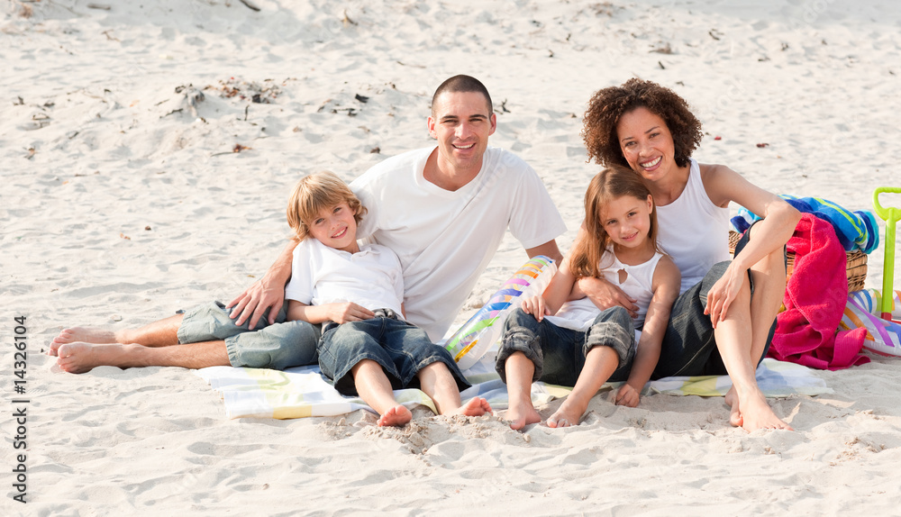 Family playing sitting on a beach Family playing sitting on a beach