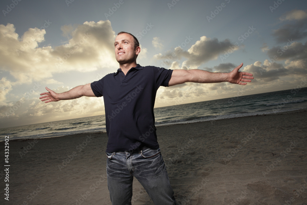 Man with arms outstretched at the beach Man with arms outstretched at the beach