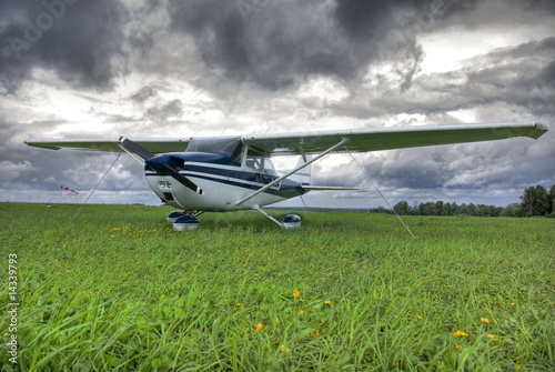 Aircraft on the field against thunderstorm clouds background photo