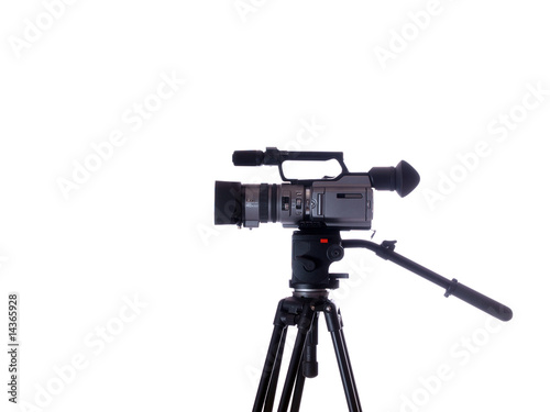 side view of mid-priced video camera on tripod