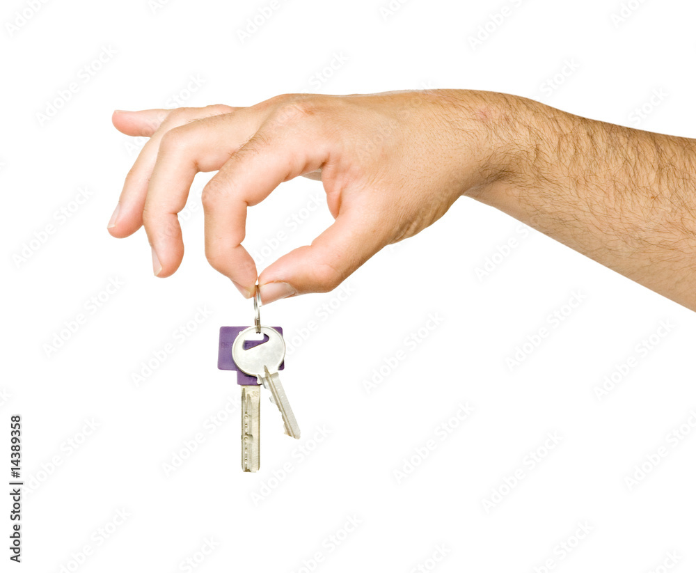 Close up of hand holding keys isolated on background Close up of hand holding keys isolated on background