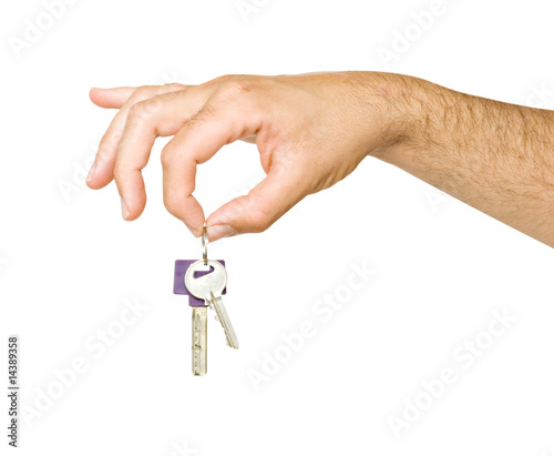 Close up of hand holding keys isolated on background