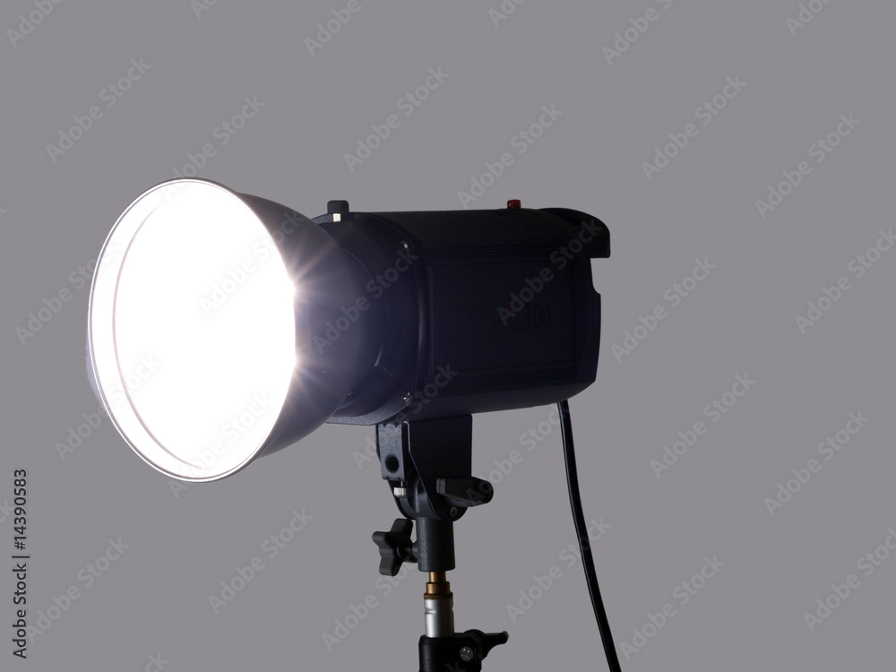 Studio monolight flash unit firing against gray background Studio monolight flash unit firing against gray background