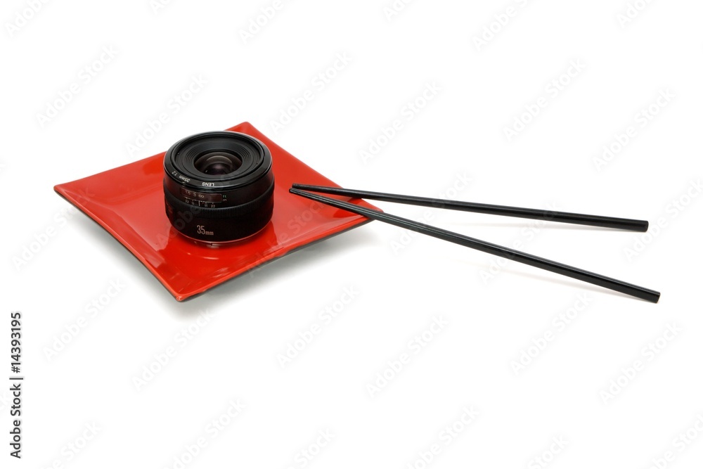 Fototapeta premium Objective lens on square plate and chopsticks isolated