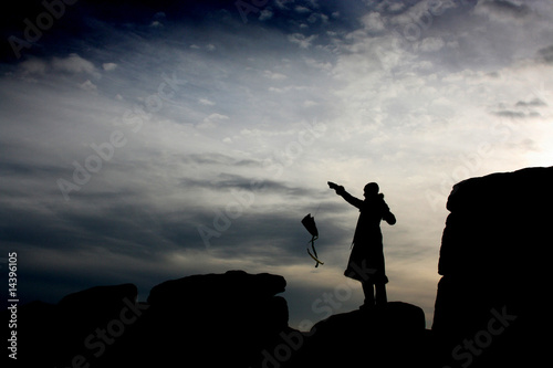 Girl flying kite on rocks, Dartmoor, England