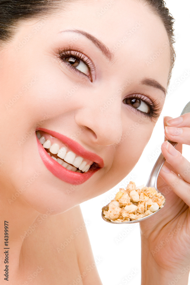 young woman eating muesli isolated on the white background young woman eating muesli isolated on the white background