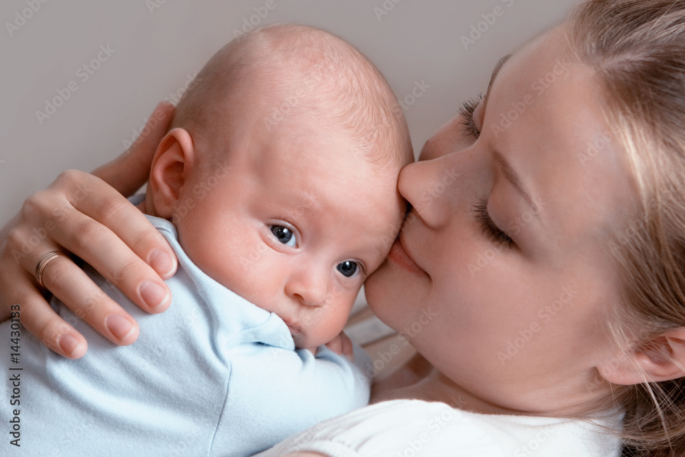 Beautiful baby of three months old in his mothers hands. Beautiful baby of three months old in his mothers hands.