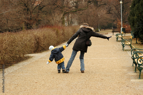 Woman and child walking in the park.
