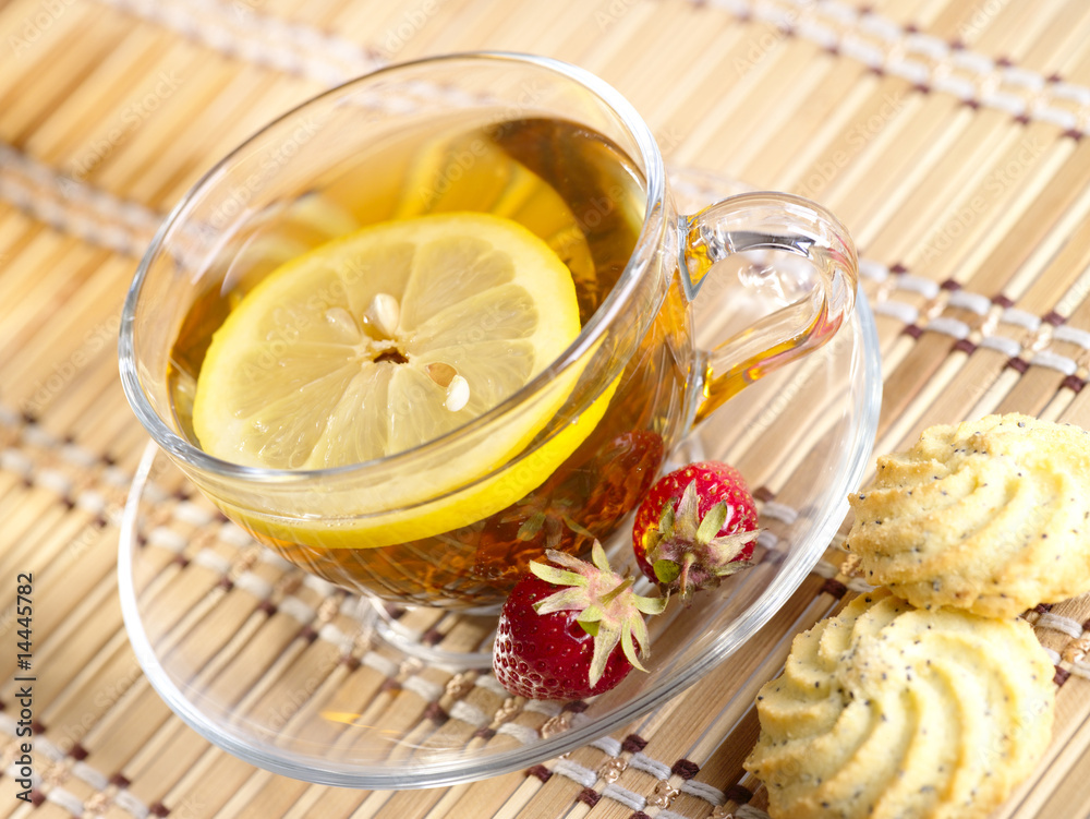 Tea with lemon fruit on bamboo background Tea with lemon fruit on bamboo background
