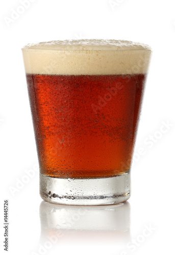 Cold glass of beer over white background