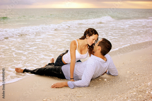 wet lovers on the beach at sunset photo