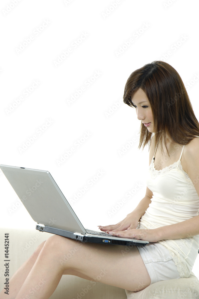happy young woman sitting on sofa using laptop happy young woman sitting on sofa using laptop