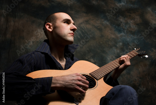 man playing acoustic guitar