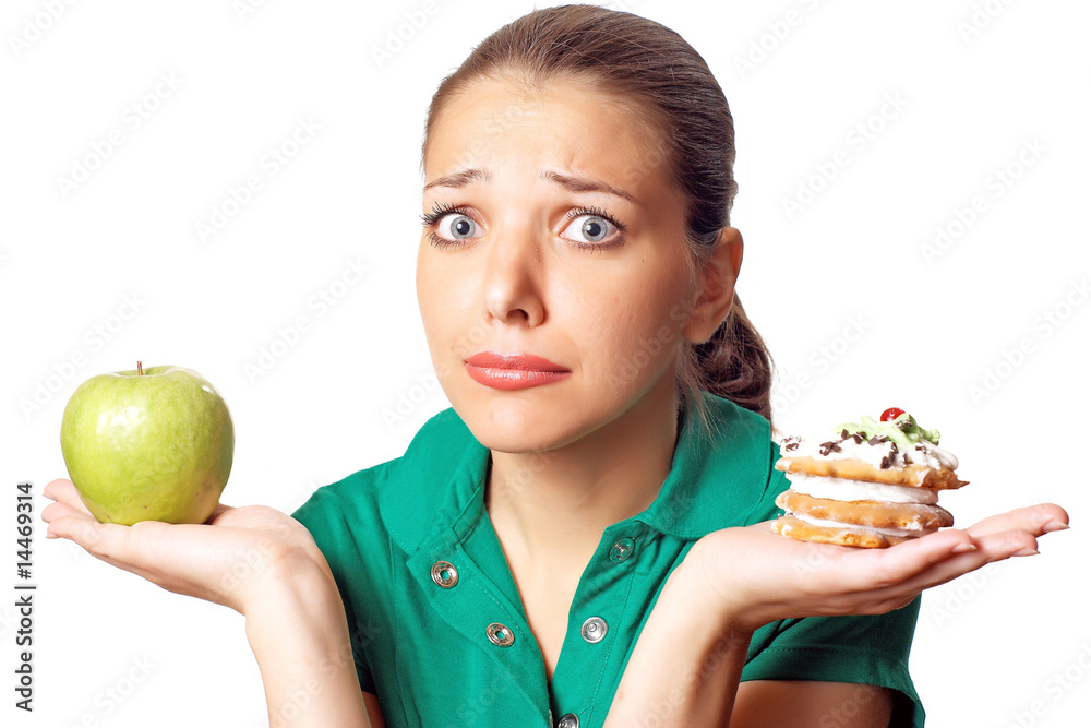 Young pretty woman. Dilema. Apple or cake. Health or tasty. Young pretty woman. Dilema. Apple or cake. Health or tasty.