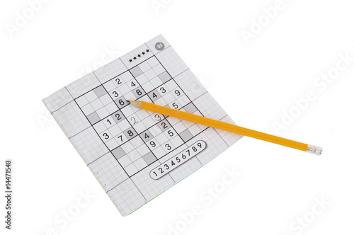 sudoku game and yellow pencil isolated on white