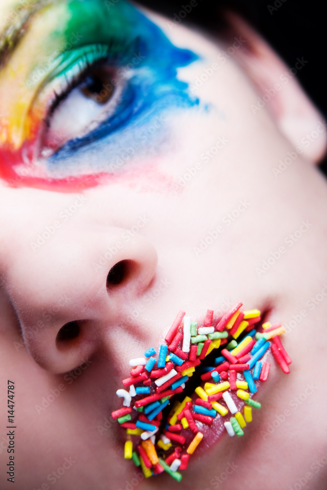 Fotografie Colorful make-up with candy on her lips