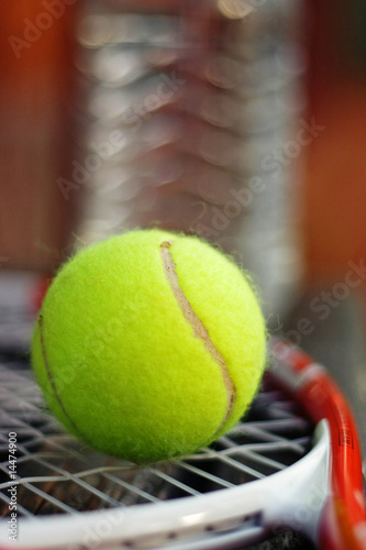 Close-up of a tennis ball on a racket