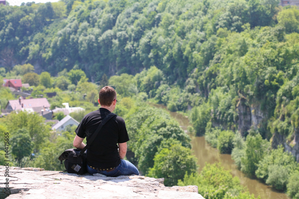 Sitting alone at the top of the precipice